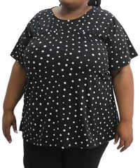 Black and white polka dot short-sleeved top worn by a stylish model