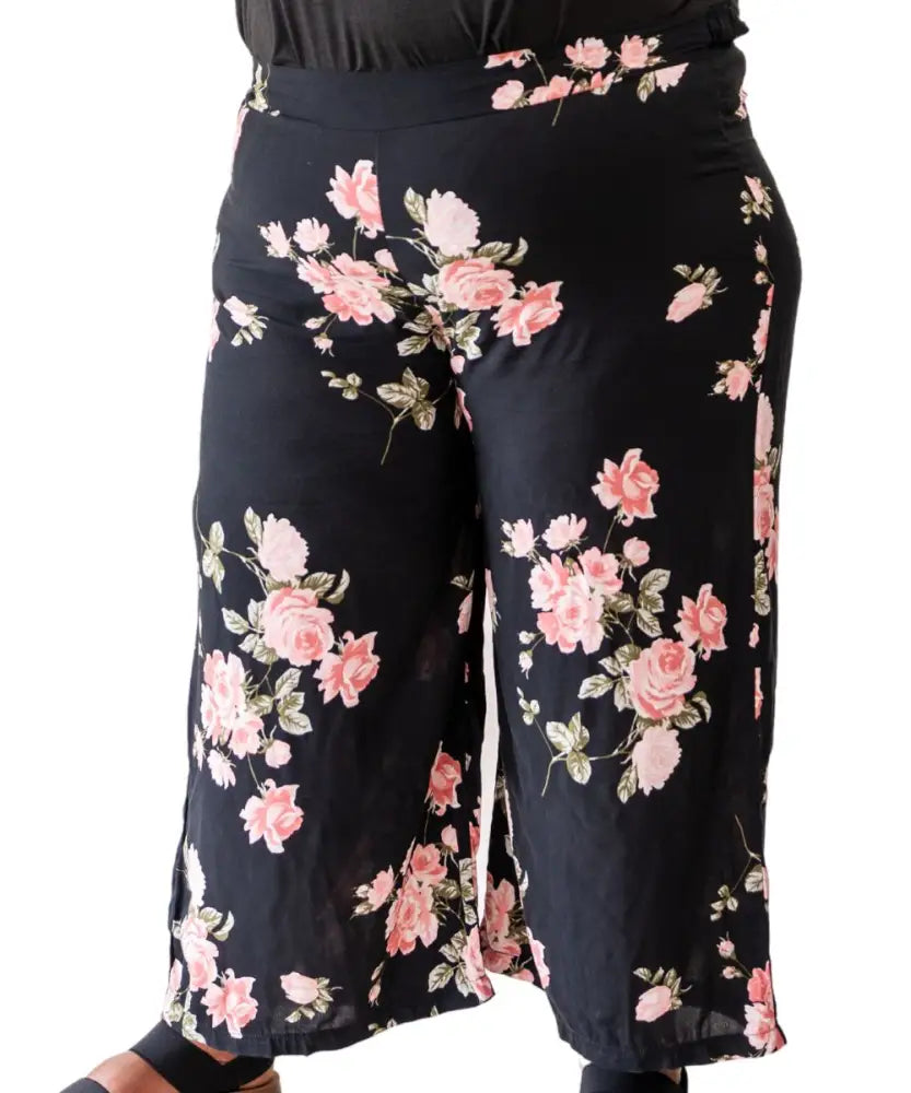 Floral-patterned ladies printed rayon capri pants with black background and pink flowers